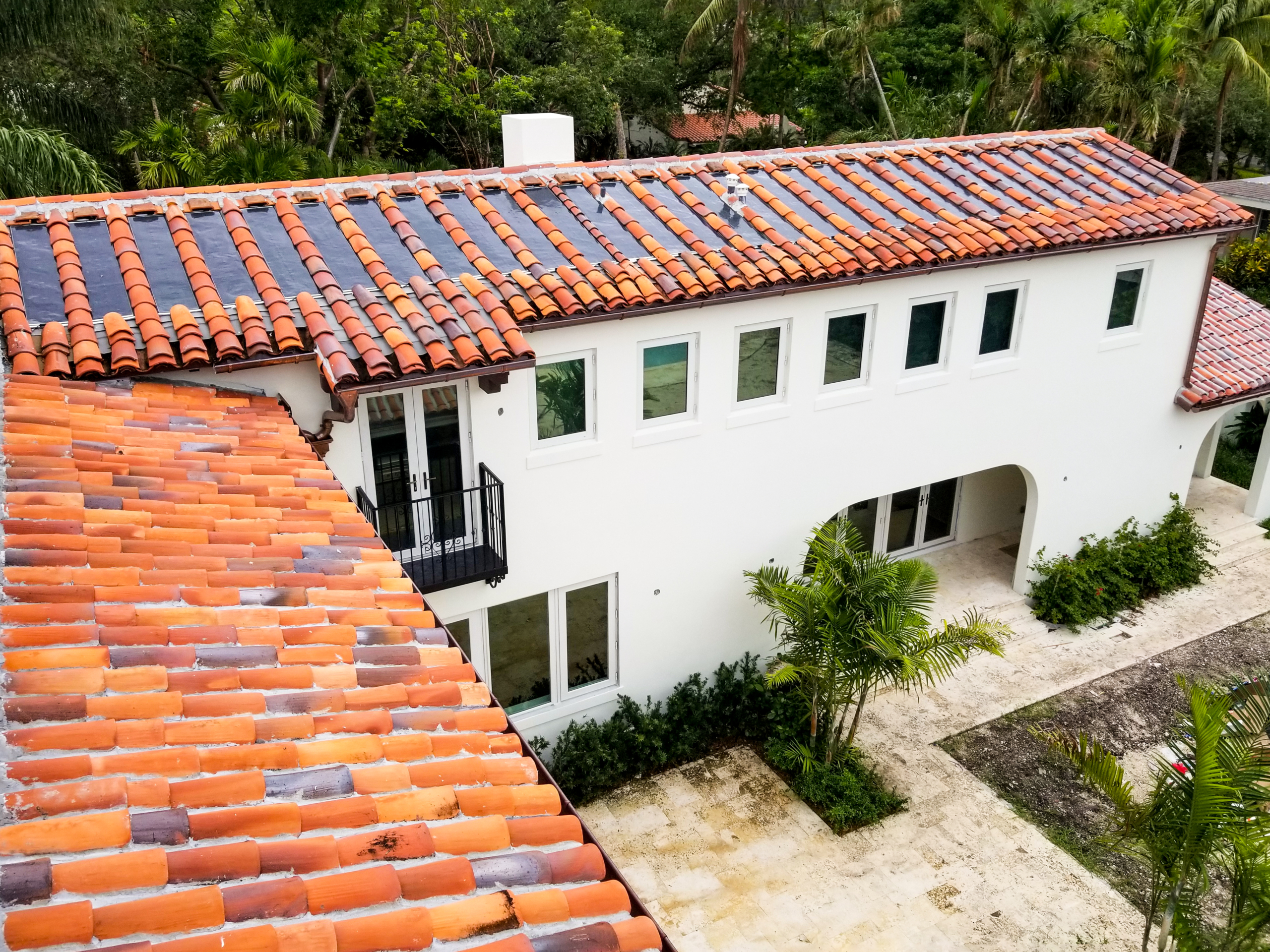 An aerial view of a house with orange tile roof.