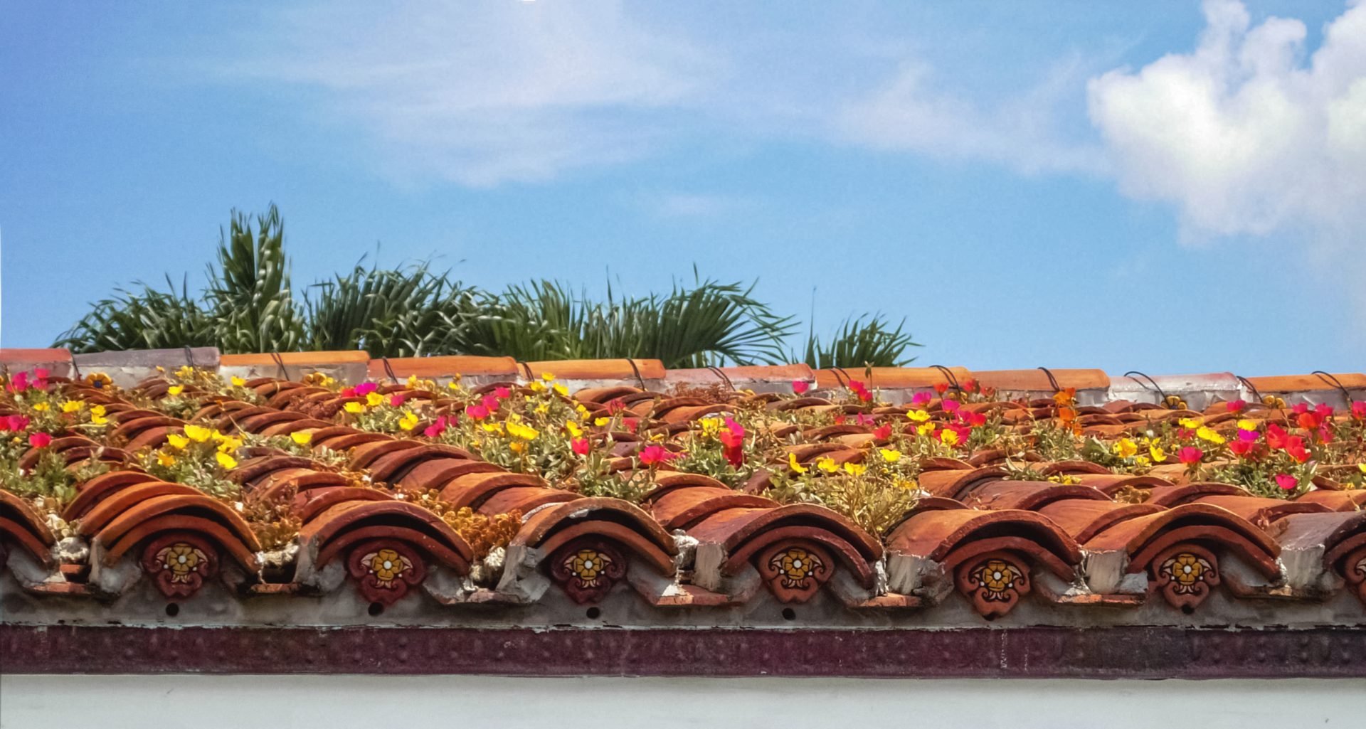 A tile roof with flowers on it.